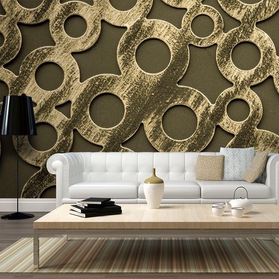 Décoration murale avec un motif doré de cercles au-dessus d'un canapé blanc.