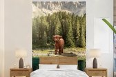 Behang - Fotobehang Schotse hooglander - Kalf - Bomen - Breedte 180 cm x hoogte 280 cm