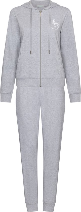 Grijs trainingspak bestaande uit een hoodie met rits en een broek. De hoodie heeft "be happy" opdruk.