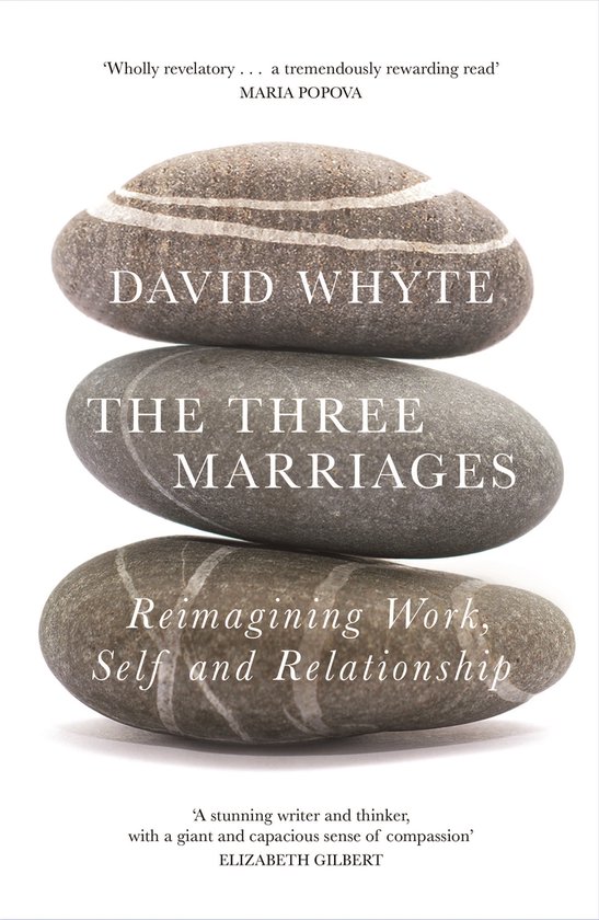 Boek 'The Three Marriages' van David Whyte, met een stapel platte stenen erop.