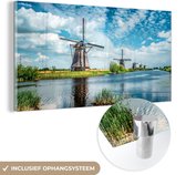 MuchoWow® Glasschilderij 40x20 cm - Schilderij acrylglas - Windmolens aan het water bij Kinderdijk - Foto op glas - Schilderijen