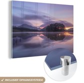 MuchoWow® Glasschilderij 120x80 cm - Schilderij acrylglas - Heuvels aan de rand van het water tijdens een zonsondergang - Foto op glas - Schilderijen