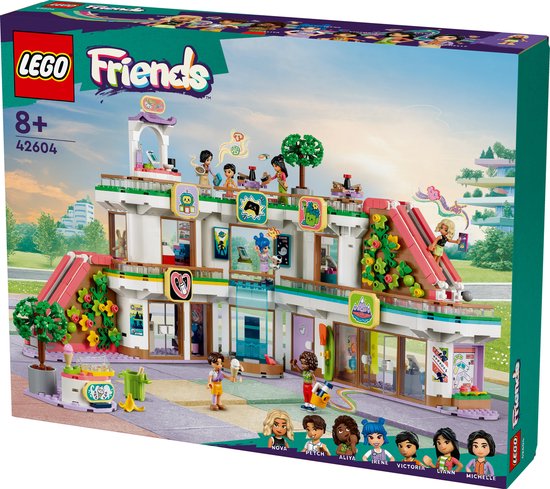 Centre commercial LEGO Friends Heartlake City 42604, un bâtiment à trois niveaux avec des toboggans roses, de nombreuses fenêtres et des mini-poupées.