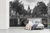 Behang - Fotobehang Brug over de Prinsengracht in Amsterdam - zwart wit - Breedte 390 cm x hoogte 260 cm