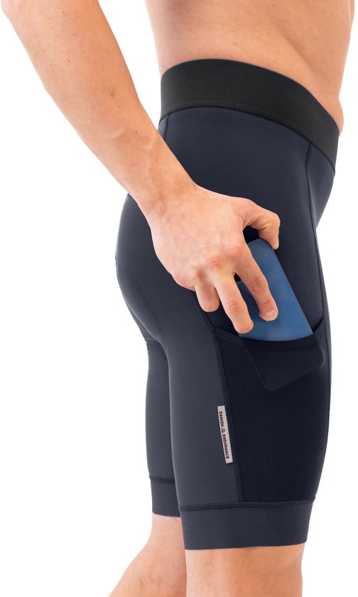 Homme portant un cuissard de cyclisme bleu marine avec une ceinture haute et une poche latérale pour téléphone.