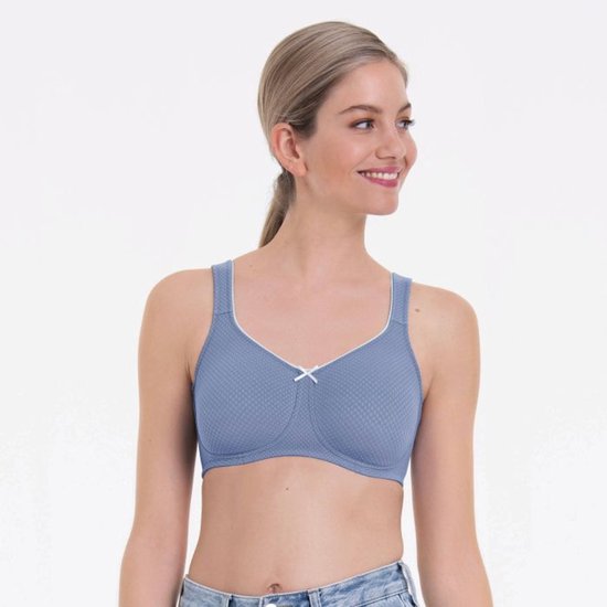 Model draagt een blauwe prothese bh met witte biezen, strikje en ruime bandjes.