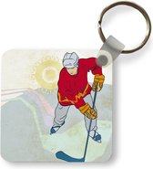 Sleutelhanger - Een illustratie van een man met een rode jas die ijshockey speelt - Plastic - Rond - Uitdeelcadeautjes