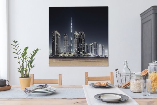 Canvas schilderij 90x90 cm - Wanddecoratie De Burj Khalifa verlicht met andere wolkenkrabbers de lucht boven Dubai - Muurdecoratie woonkamer - Slaapkamer decoratie - Kamer accessoires - Schilderijen op canvas