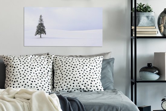 Tableau sur toile Un vide enneigé avec un sapin - 80x40 cm - Décoration murale