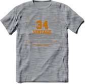 34 Jaar Legend T-Shirt | Goud - Zilver | Grappig Verjaardag Cadeau | Dames - Heren | - Donker Grijs - Gemaleerd - XL