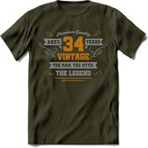 34 Jaar Legend T-Shirt | Goud - Zilver | Grappig Verjaardag Cadeau | Dames - Heren | - Leger Groen - L