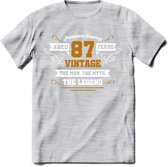 87 Jaar Legend T-Shirt | Goud - Wit | Grappig Verjaardag en Feest Cadeau Shirt | Dames - Heren - Unisex | Tshirt Kleding Kado | - Licht Grijs - Gemaleerd - L