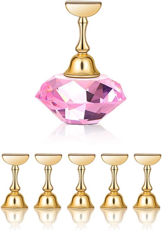 Supports d'affichage d'ongles dorés avec un grand diamant de cristal rose.
