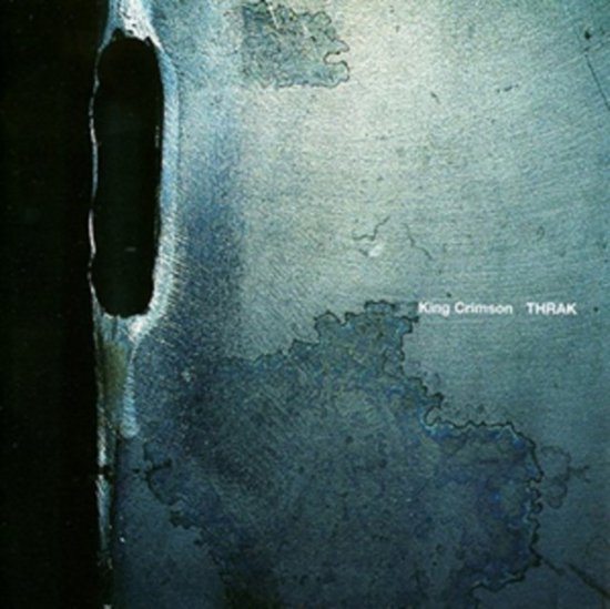 King Crimson THRAK albumhoes met blauwgroene verweerde textuur en een verticale gleuf aan de linkerkant.