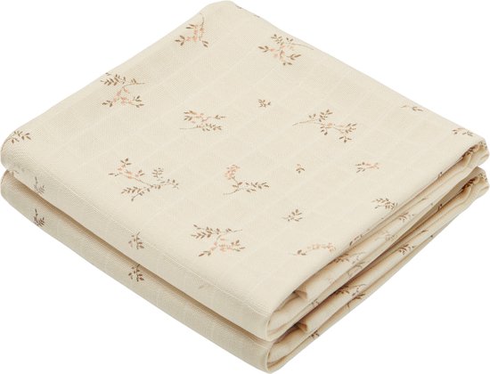 Lichtbeige hydrofiele doek, gevouwen, met een subtiel bloemen- en takjespatroon.