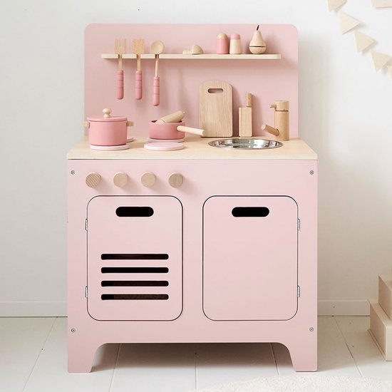 Roze houten speelgoedkeuken met fornuis, gootsteen, plank en houten accessoires zoals potten, bestek en snijplank.
