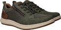 Paar groene sneakers met rits en bruine accenten, vanuit een hoek.