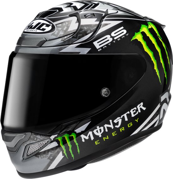 Zwarte HJC integraalhelm met witte en groene Monster Energy graphics, 'BS BATTERY' en 'MONSTER ENERGY' logo's, en een donker vizier.