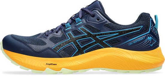 Zijprofiel van marineblauwe trailschoenen met oranje zolen en zwarte/blauwe ASICS-strepen.