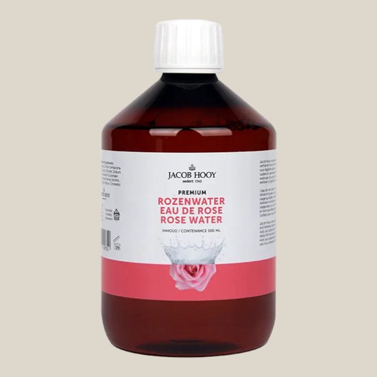 Jacob Hooy Premium Rozenwater Eau de Rose Rose Water 500ml met een roze roos in een water splash.