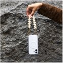 Een hand houdt een telefoonhoesje met lanyard adapter vast. De adapter is een koord van beige hartjes.