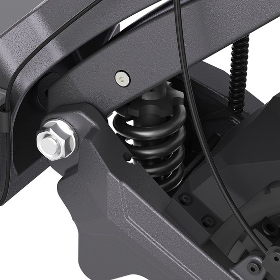 Close-up van de schokdemper aan de voorzijde van de elektrische scooter, met zwarte veer.