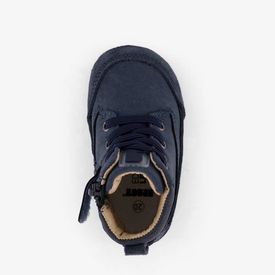 Bovenkant donkerblauwe babyschoen met veters en rits, beige voering met maat 20.
