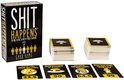 Doos en kaarten voor het Shit Happens kaartspel. De doos heeft 'SHIT HAPPENS' in grote zwarte letters. Vier kaarten liggen voor de doos met tekst en een 'Misery Index'.