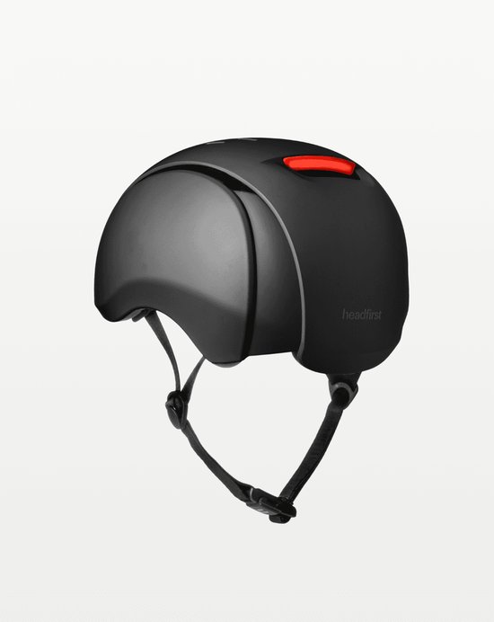 Zwarte Headfirst fietshelm met een rood remlicht aan de achterkant.