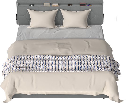 Grijs gestoffeerd bedframe met kapblok, twee kussens, lichte dekens en een deken met blauw-witte patroon.