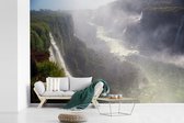 Behang - Fotobehang Meerdere watervallen en het mistige jungle landschap van het Nationaal park Iguazú in Argentinië - Breedte 390 cm x hoogte 260 cm