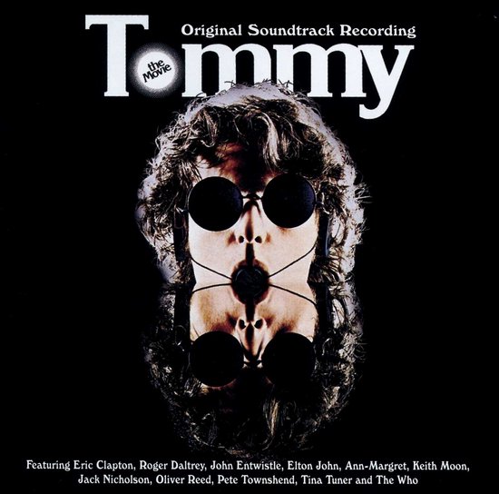 Albumcover met in het midden een symmetrisch portret van een man met zonnebril, omringd door krullend haar. "Tommy The Movie" staat bovenaan.