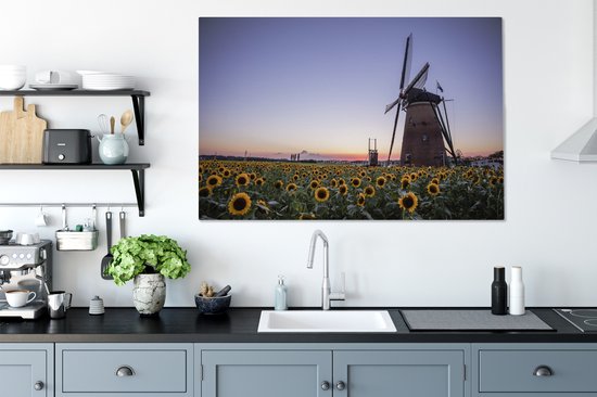 Tableau sur toile Vieux moulin à vent se dresse dans un champ avec des tournesols - 120x80 cm - Décoration murale