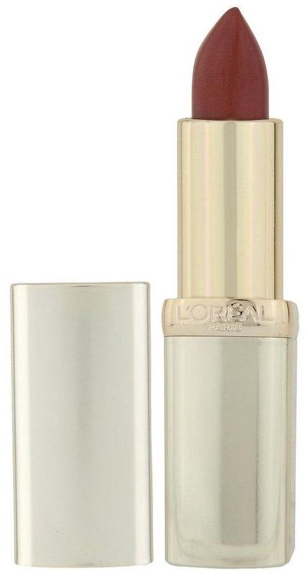 Gouden huls met een matte bruinrode lipstick punt. De zilveren dop ligt ernaast.
