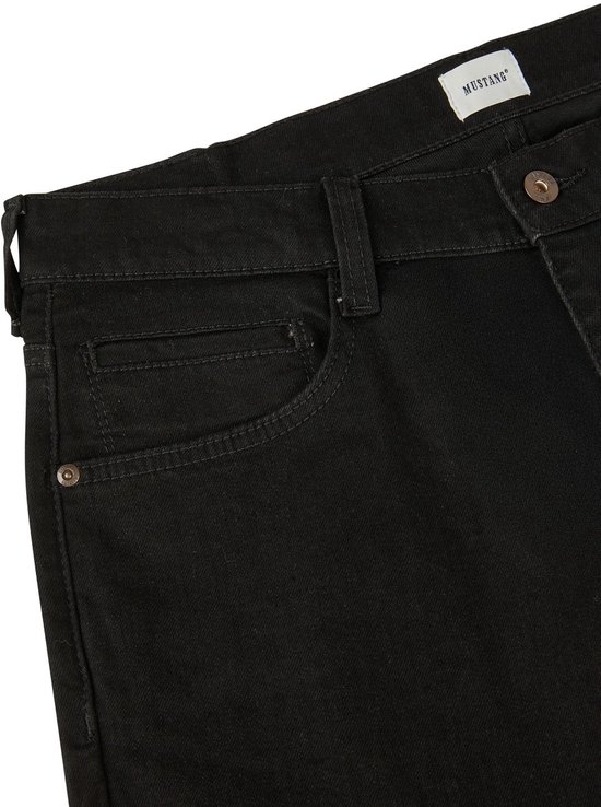 Detail van de tailleband van een zwarte jeans. De broek heeft een knoopsluiting en het Mustang logo op een leren patch.