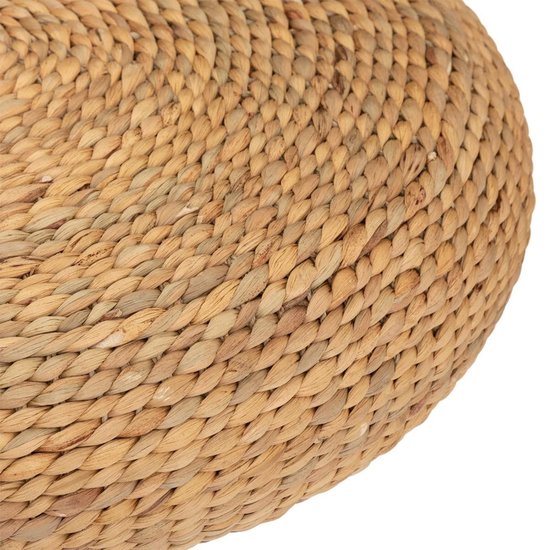 Close-up van een ronde, gevlochten poef van natuurlijk materiaal.