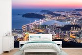 Behang - Fotobehang Uitzicht over een verlicht Busan in Zuid-Korea - Breedte 330 cm x hoogte 220 cm