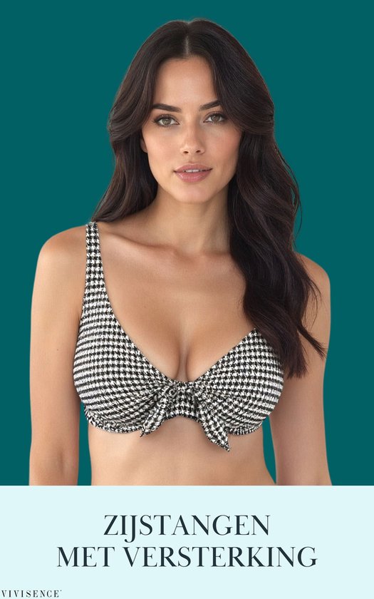 Mannequin portant un bikini noir et blanc à chevrons avec un nœud sur le devant.