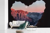 Behang - Fotobehang Zonsondergang vanuit grot - Breedte 450 cm x hoogte 300 cm