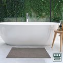 Grijze badmat met bobbelstructuur voor een moderne badkamer met ligbad.