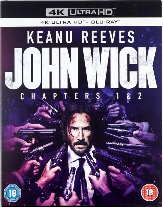 Keanu Reeves als John Wick, omringd door pistolen, op de voorkant van de Blu-ray hoes.