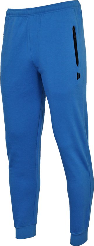 Kobaltblauwe joggingbroek met een zwarte ritssluiting op de linkerheup en een zwart logo, op een witte achtergrond.
