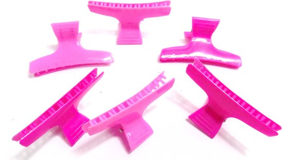 Zes roze, flexibele kappersklemmen in verschillende tinten.