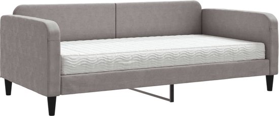 Grijze stoffen slaapbank met een wit matras en zwarte poten.