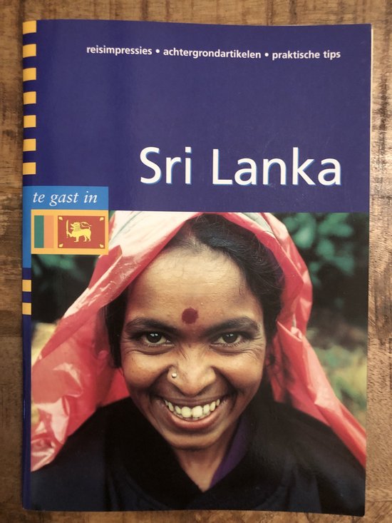 Reisgids Sri Lanka met een lachende vrouw met rode sjaal en stip op voorhoofd. "Sri Lanka te gast in"