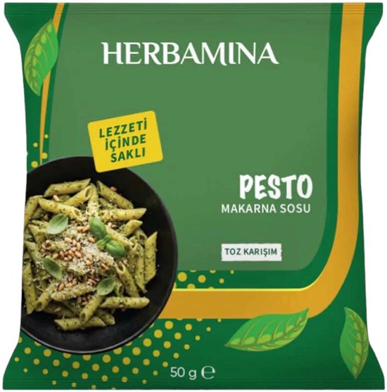 Herbamina Pesto pastasaus mix. Met groene bladeren en een kom met pesto pasta.