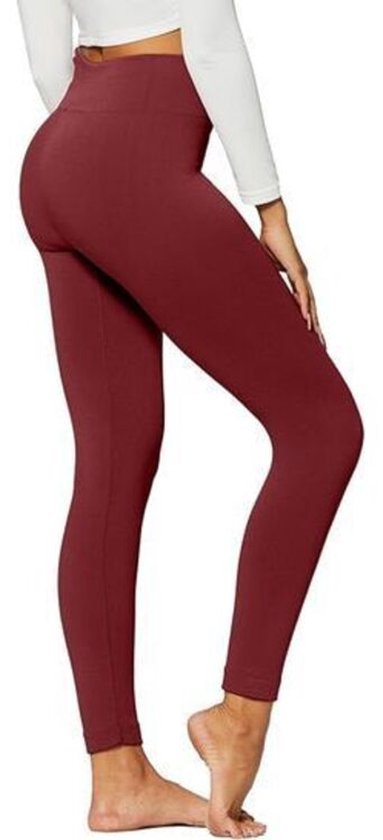 Zijaanzicht van een bordeauxrode legging met hoge taille, gedragen met witte top.