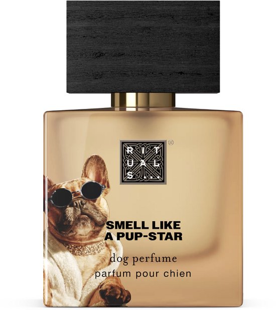 Gouden parfumfles met zwart houten dop. Op het etiket een Franse bulldog met zonnebril en een badjas. Tekst: 'SMELL LIKE A PUP-STAR dog perfume parfum pour chien'.