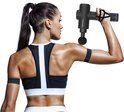 Vrouw in sportkleding gebruikt een zwart Northwall massagepistool op haar schouderspier.