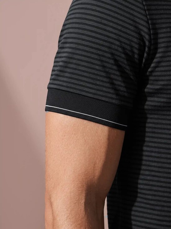 Close-up van de mouw van een zwart-grijs gestreept poloshirt met een witte bies op de boord.